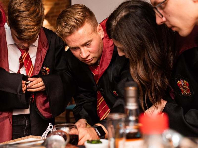 Leidenschaftliche Harry-Potter-Fans perfektionieren ihre Party mit ikonischen Gryffindor-Umhängen.. © Ekaterina Soldatenko/Shutterstock.com