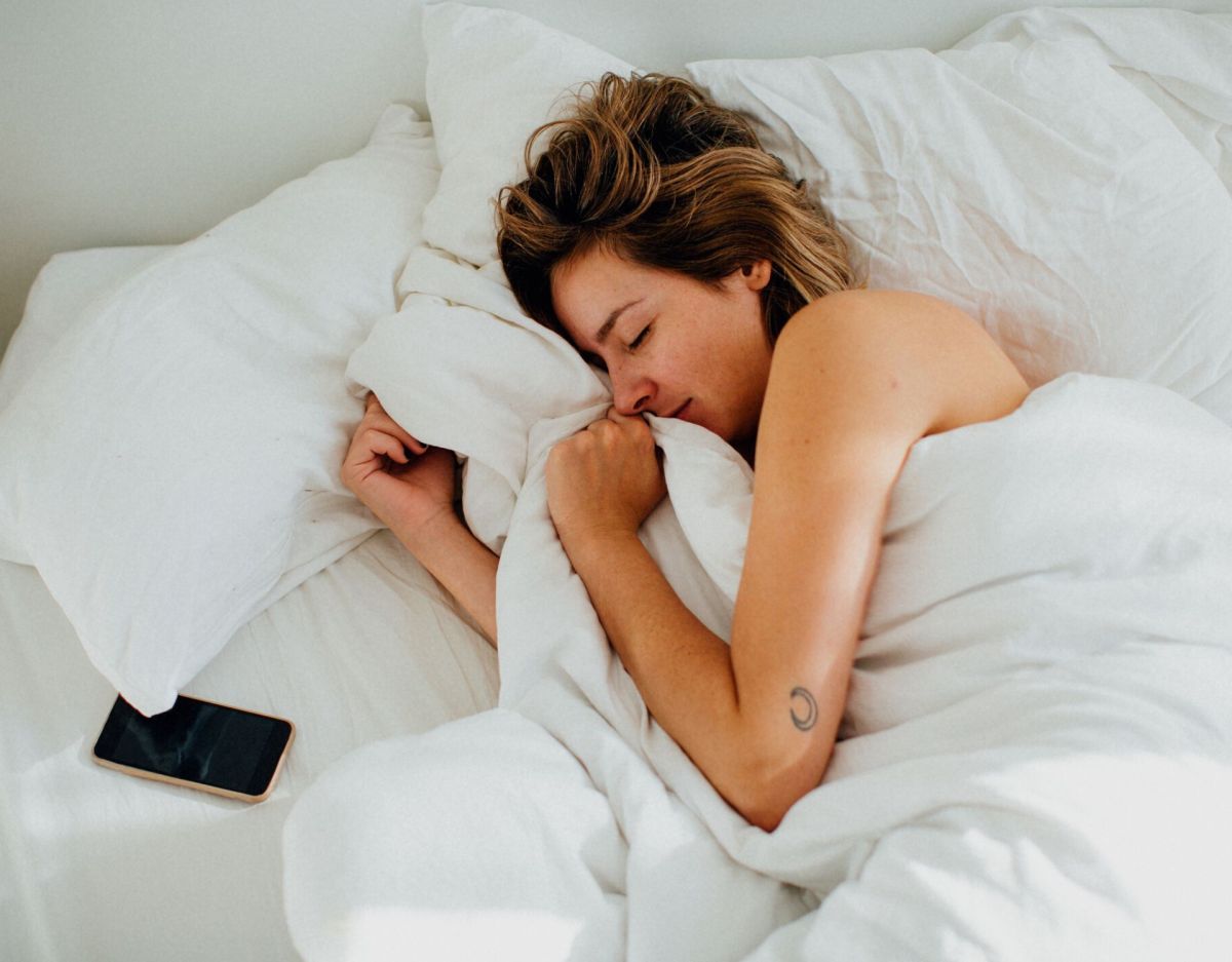 Frau im Bett mit Smartphone