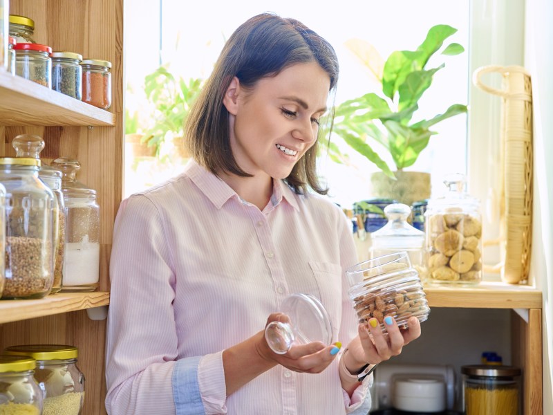 Frau mit Nüssen in einem Glas