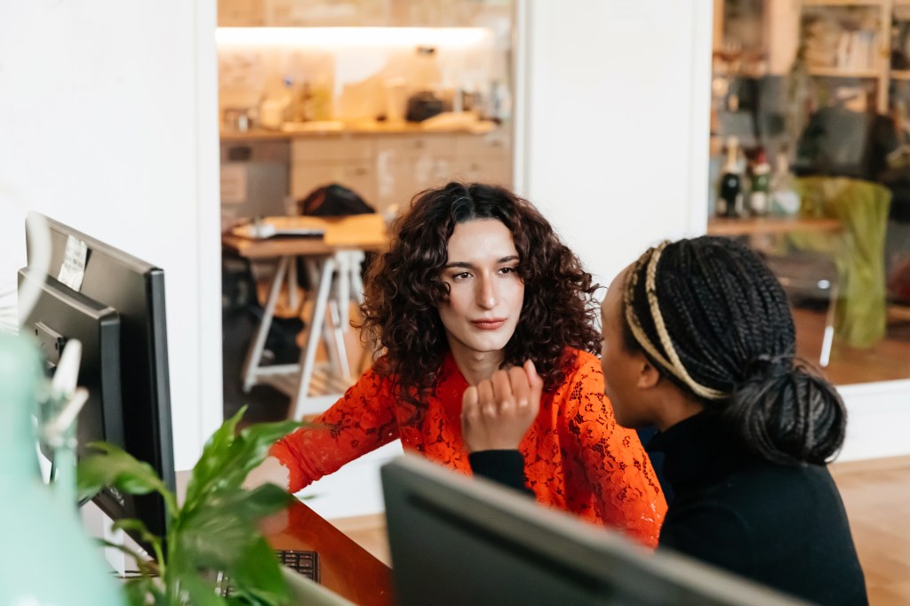 Zwei Frauen sprechen auf der Arbeit miteinander