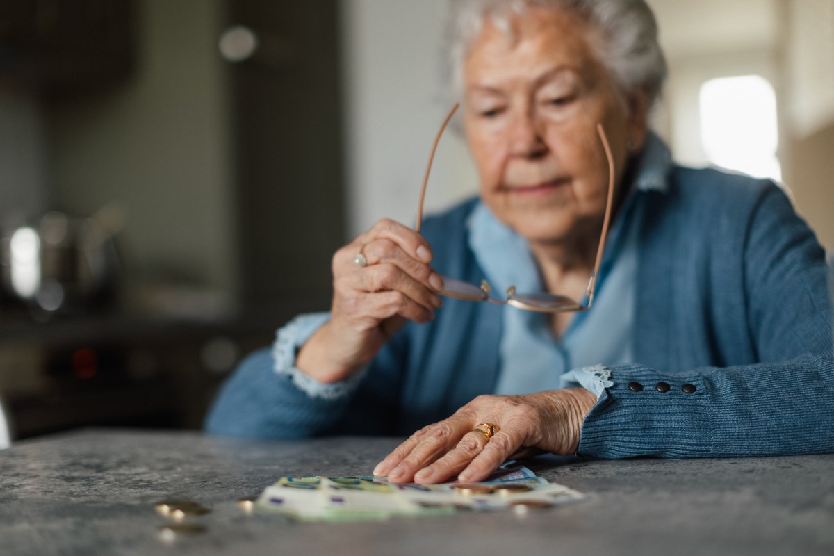 Seniorin schaut sich ihr Geld an.