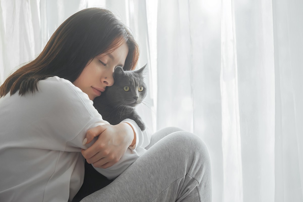 Frau kuschelt mit Katze