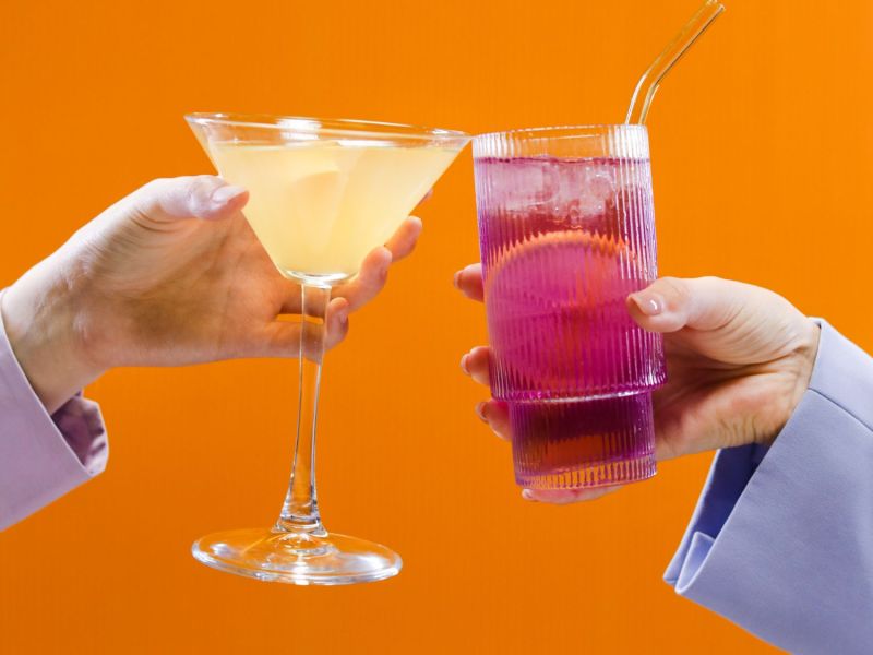 Zwei Menschen, die mit eiskalten Cocktails anstoßen