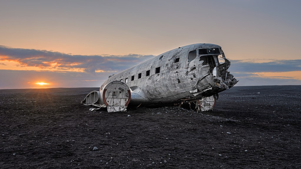 Bei Sonnenuntergang aufgenommen: Das Wrack eines Absturzes von 1973, eine DC-3, die in S&oacute;lheimasandur, Island, abst&uuml;rzte, nachdem ihr der Treibstoff ausgegangen war.