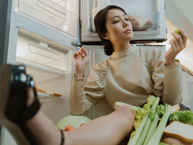 Frau vor Kühlschrank