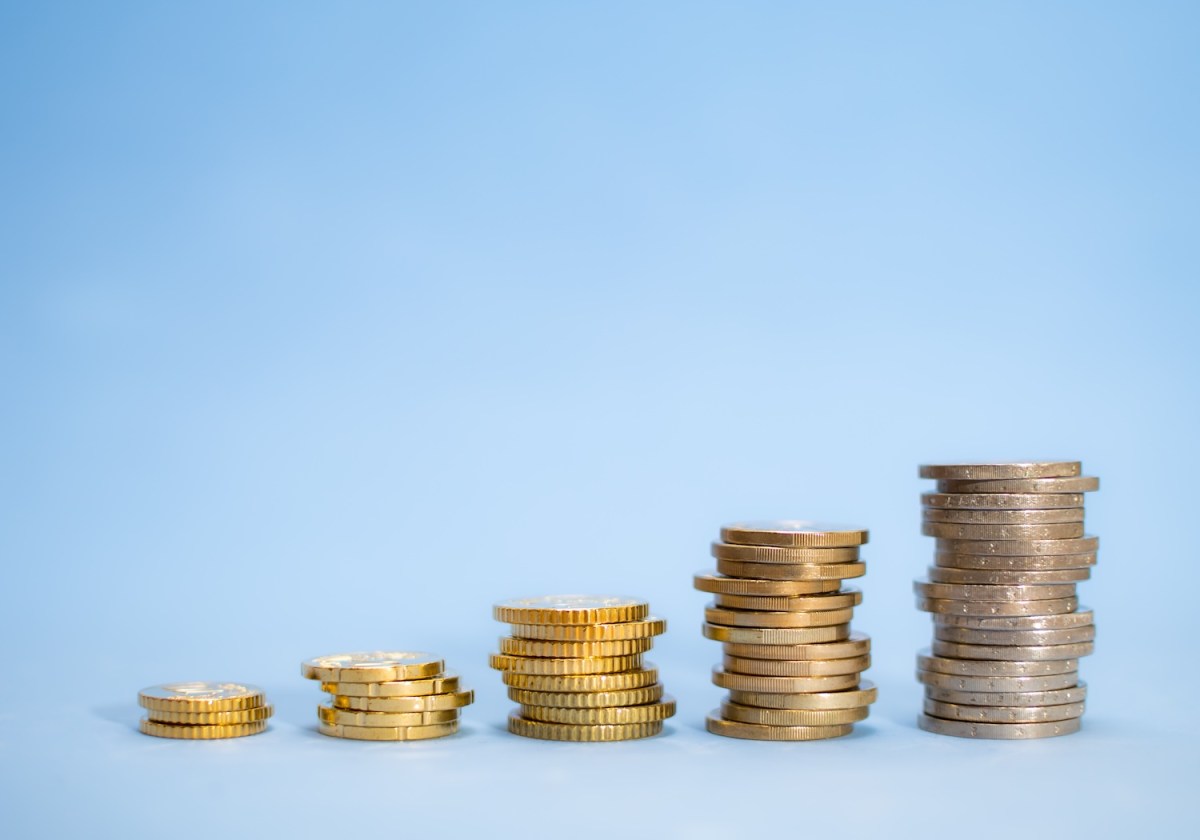 Mehre Münzstapel auf blauen Hintergrund.