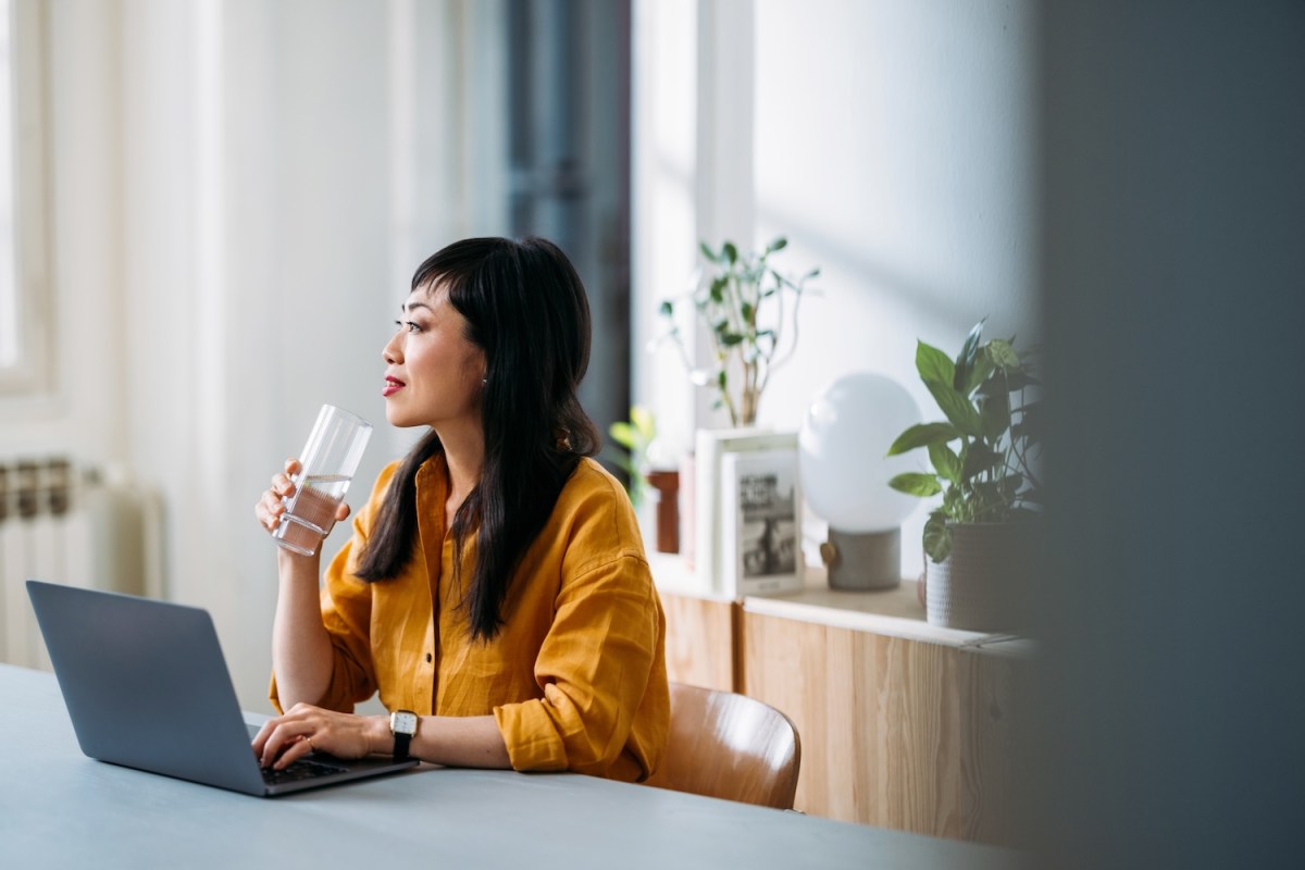 Frau macht eine Pause mit einem Glas Wasser.
