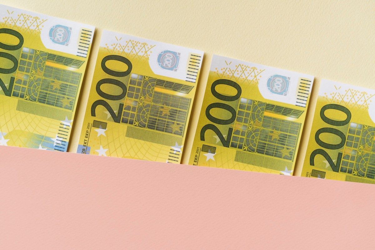 200-Euro Geldscheine auf pastellfarbenem Hintergrund.