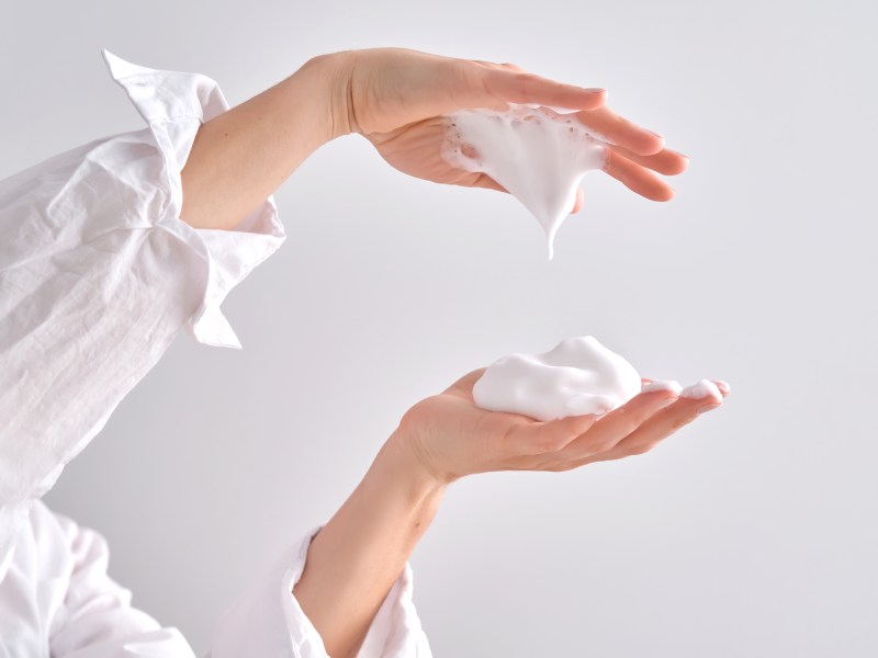 Frau hat Schaumfestiger zwischen den Händen